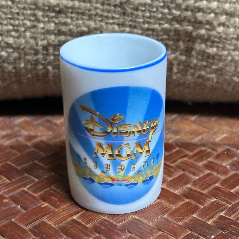 Disney MGM Studios Blue,Gold, & white shot glass or toothpick holder Dated 1987
